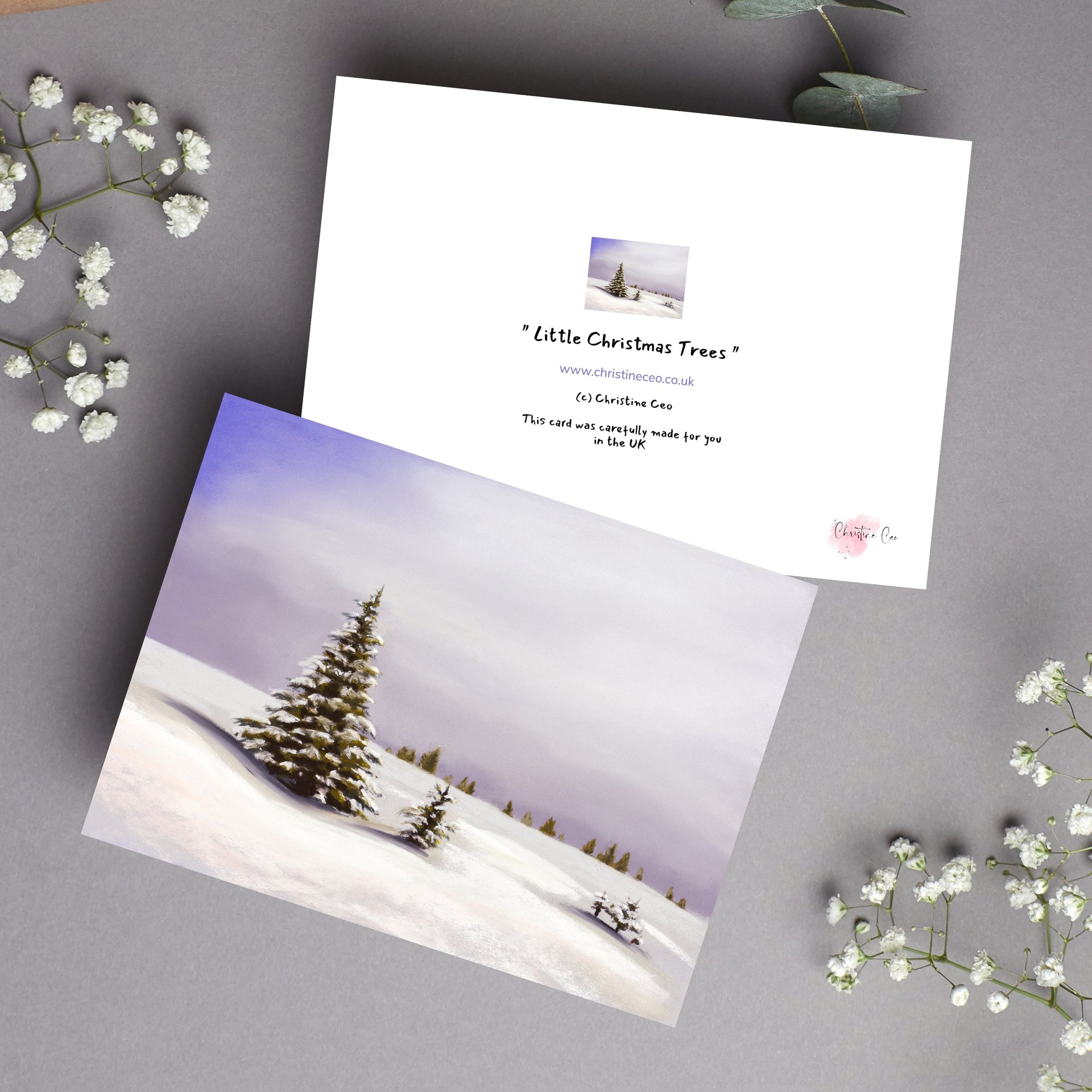 Greeting card with snow covered fir trees painting. Front and back view of card