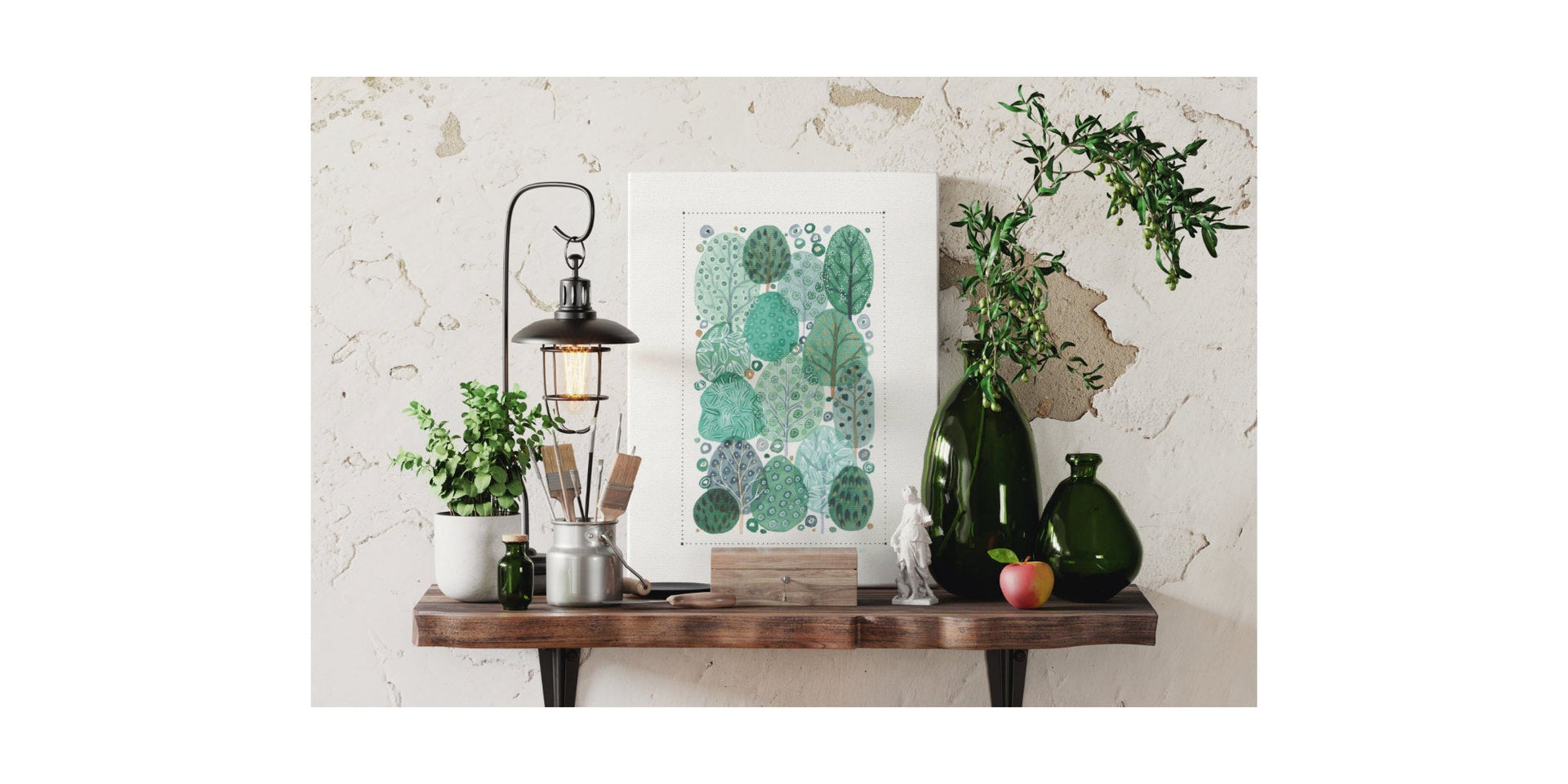 Artwork canvas print with a modern woodland trees design on a wooden shelf with a lamp, glass vases and ornaments