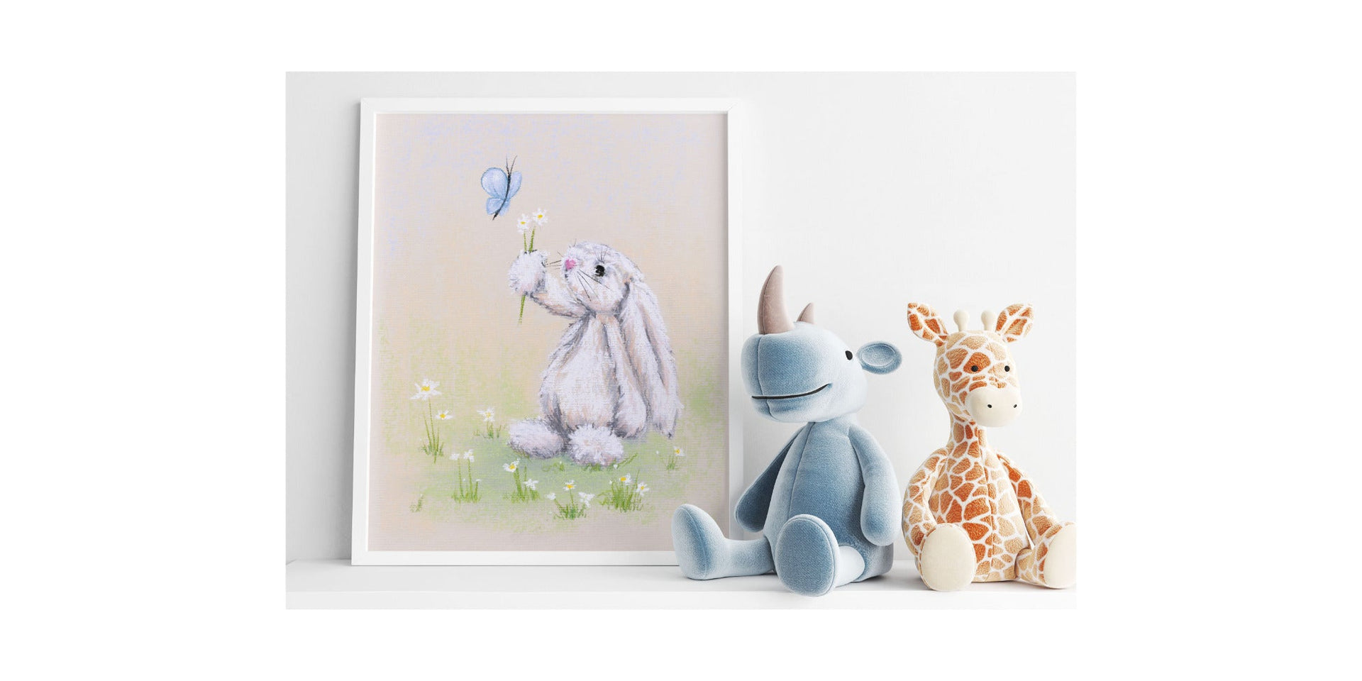 White rabbit offering a small posy of daisy flowers to a butterfly illustration art print in white frame on a shelf next to a blue hippopotamus and a giraff soft toys