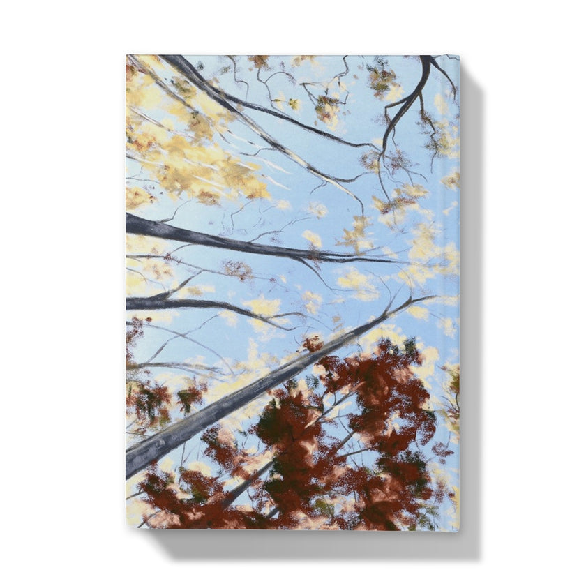 Notebook with tree canopy and leaf design on a blue background. back cover