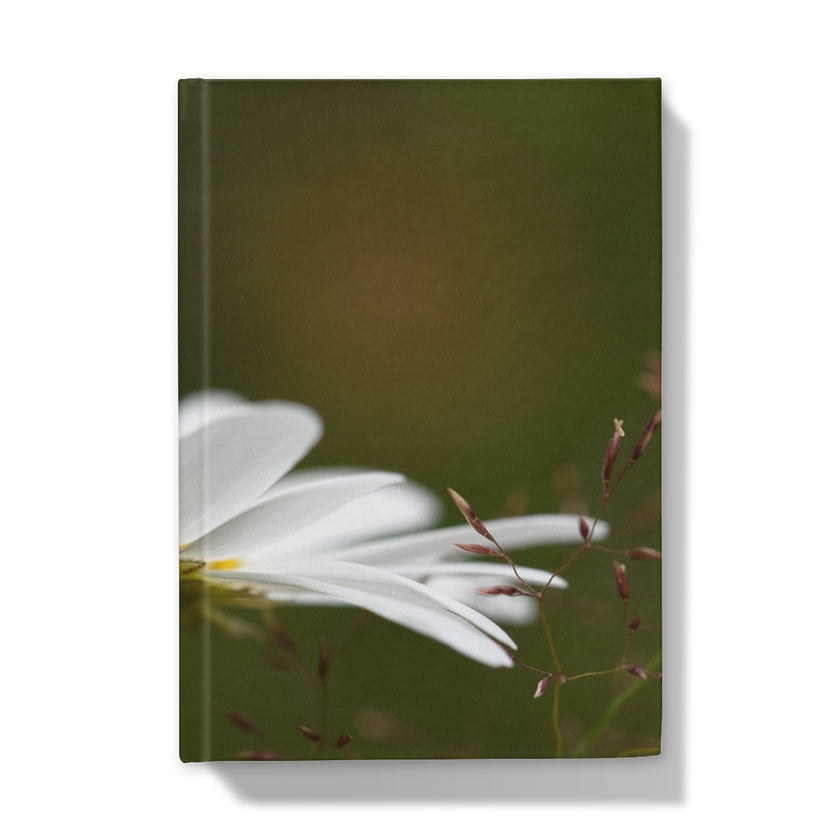 Journal with a white flower and green background. front cover