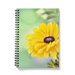 Notebook with a yellow flower design on a mint green and lilac background