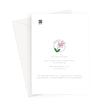 Greeting card back. A white card with printed text and a small pink flower illustration, shown with a white envelope behind it on a light gray background.