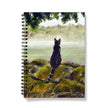 Notebook with a cat illustration on a nature-themed cover