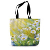 Tote bag with a floral design of daisies illuminated by sunshine