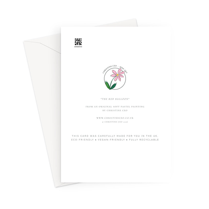 Greeting card back view. A white card with printed text and a small floral illustration, shown with a white envelope behind it on a light gray background.