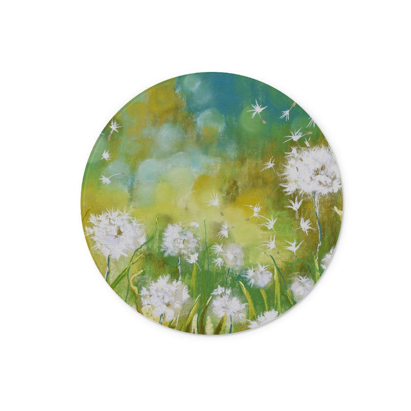 Round chopping board with a floral design featuring white fluffy dandelion seed heads. 