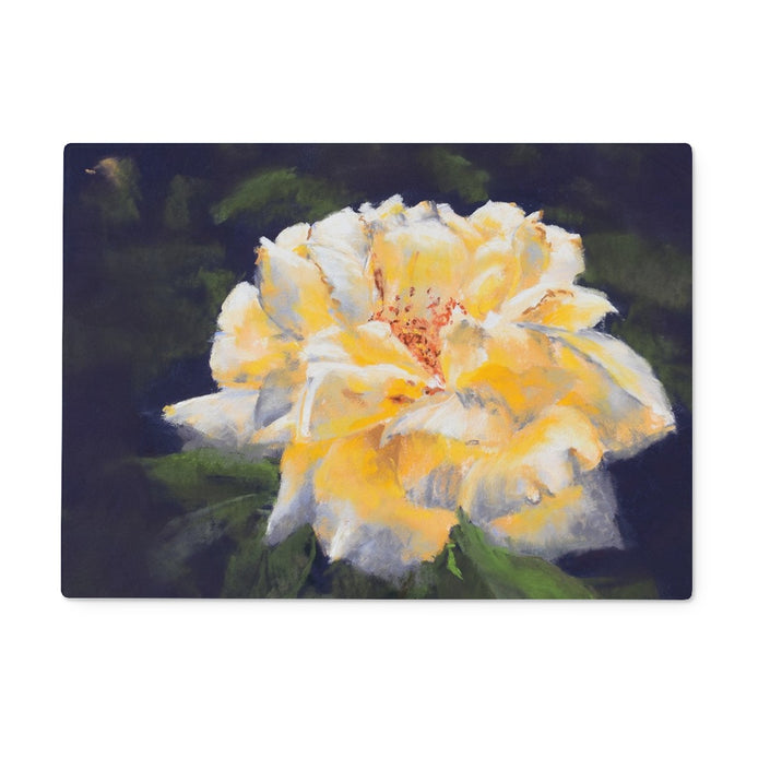 Rectangular chopping board with a Yellow rose with green leaves on a dark background