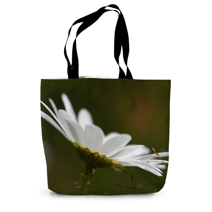 Tote bag with a white flower design on a green background