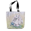 Tote bag with an artwork design of a rabbit holding a watering can standing among the daisies