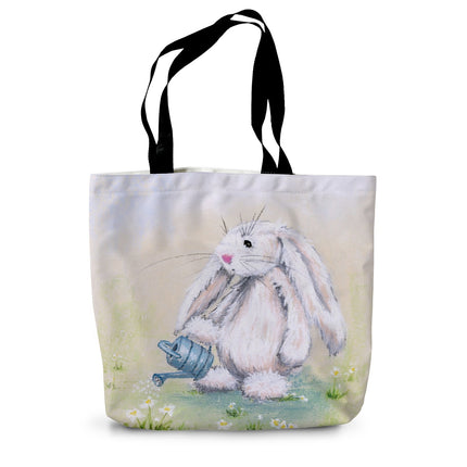 Tote bag with an artwork design of a rabbit holding a watering can standing among the daisies