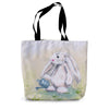 Tote bag with an artwork design of a rabbit holding a watering can standing among the daisies