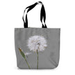 Tote bag with a dandelion design on a grey background