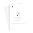 Greeting card back. A white card with printed text and a small pink flower illustration, shown with a white envelope behind it on a light gray background.