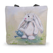 Tote bag with an artwork design of a rabbit holding a watering can standing among the daisies