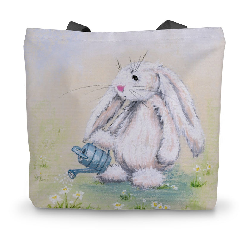 Tote bag with an artwork design of a rabbit holding a watering can standing among the daisies