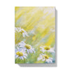 Notebook with a floral design, featuring white daisies in the sunshine. front cover