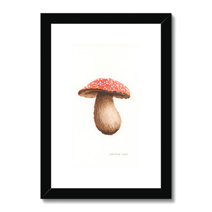 Framed artwork of a mushroom with a red cap with a black frame