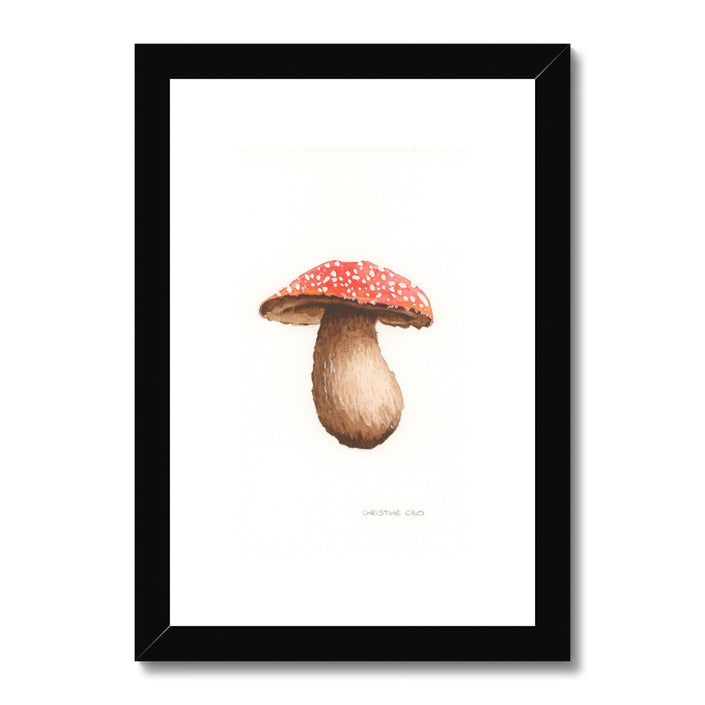 Framed artwork of a mushroom with a red cap with a black frame