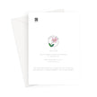 Greeting card back. A white card with printed text and a small pink flower illustration, shown with a white envelope behind it on a light gray background.