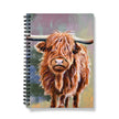 Notebook with a Scottish highland cow illustration on the cover