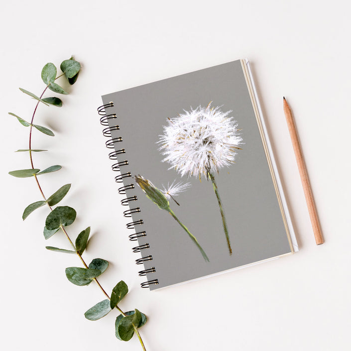 Dandelion seed artwork design spiral bound notebook. Grey and white cover design