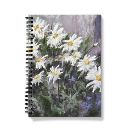 Notebook with a floral design on the cover featuring white flowers on a colourful background