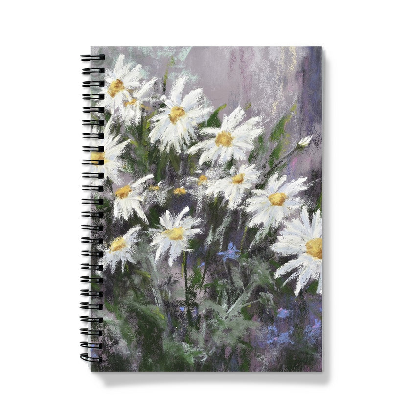 Notebook with a floral design on the cover featuring white flowers on a colourful background