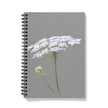 Notebook with white floral design on a gray background