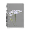 Notebook with white floral design on a gray background