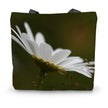Tote bag with a white flower design on a green background