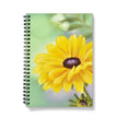 Notebook with a yellow flower design on a mint green and lilac background