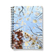 Notebook with a cover design of trees against a blue sky