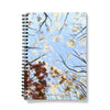 Notebook with a cover design of trees against a blue sky
