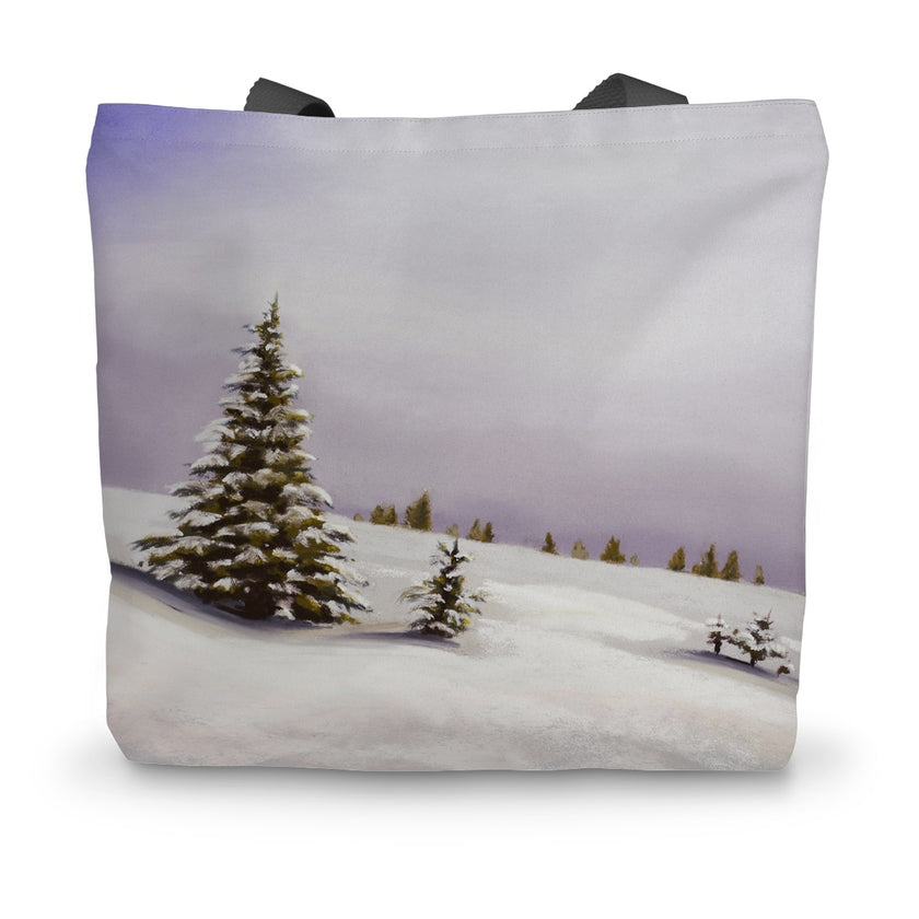 Tote bag with a winter landscape design featuring trees and snow.