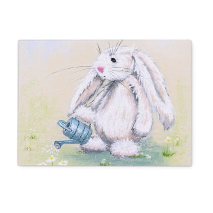 Rectangular chopping board. Illustration of a fluffy white bunny holding a blue watering can on a light background