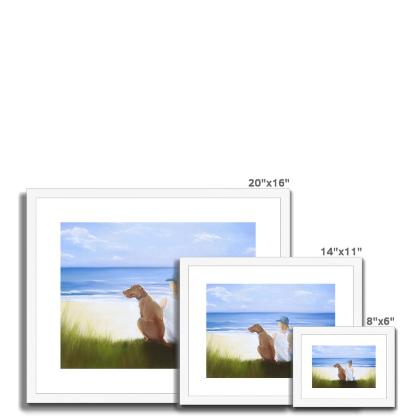 Boy and dog sitting overlooking the beach. Painting. Art print in white frame with white mount. 3 different sizes