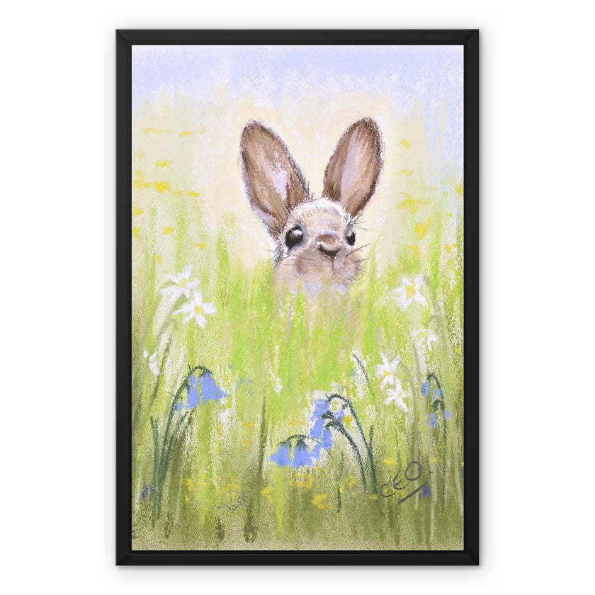 Brown Rabbit peeping over the meadow flowers canvas artwork print with black picture frame. 