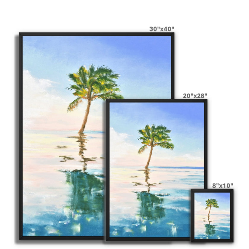 Palm tree set against blue sky and reflecting in clear turquoise water. Canvas print in a black frame. Different sizes